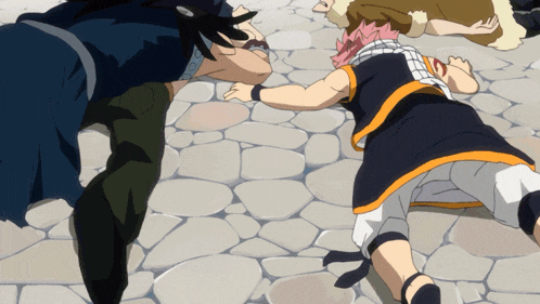 a group of people are laying on the ground and one of them has pink hair