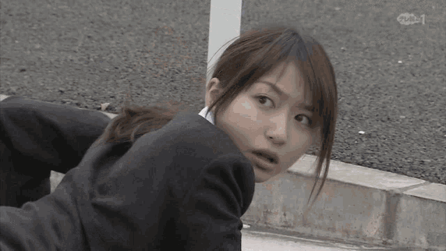 a woman in a suit is looking over her shoulder at the camera with the letters ntv on the bottom right