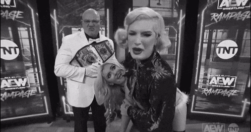 a black and white photo of a wrestler holding a championship