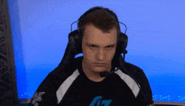 a man wearing headphones and a shirt with the letter g on the sleeve