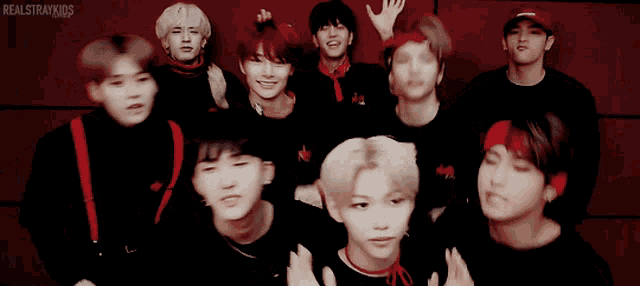 a group of young men are posing for a picture and the words realstraykids are on the bottom right
