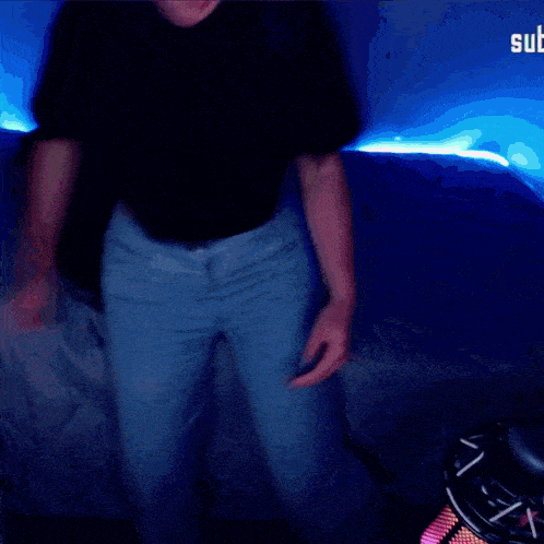 a person in a black shirt and blue jeans dancing