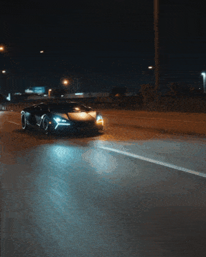 a car is driving down a road at night