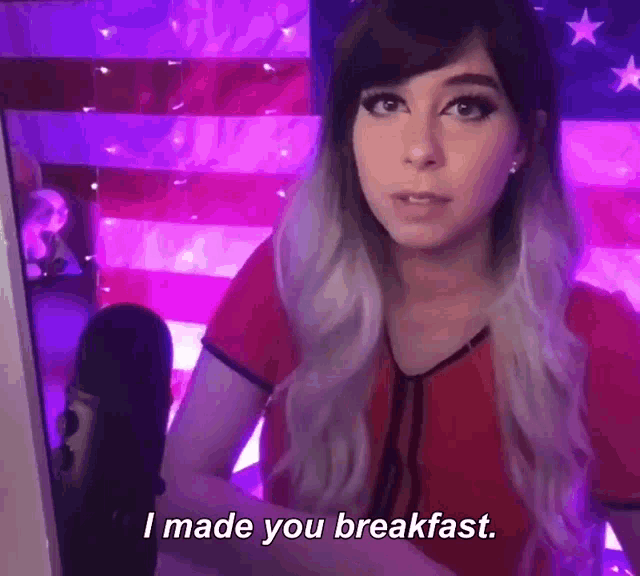 a woman is sitting in front of a microphone and says i made you breakfast .