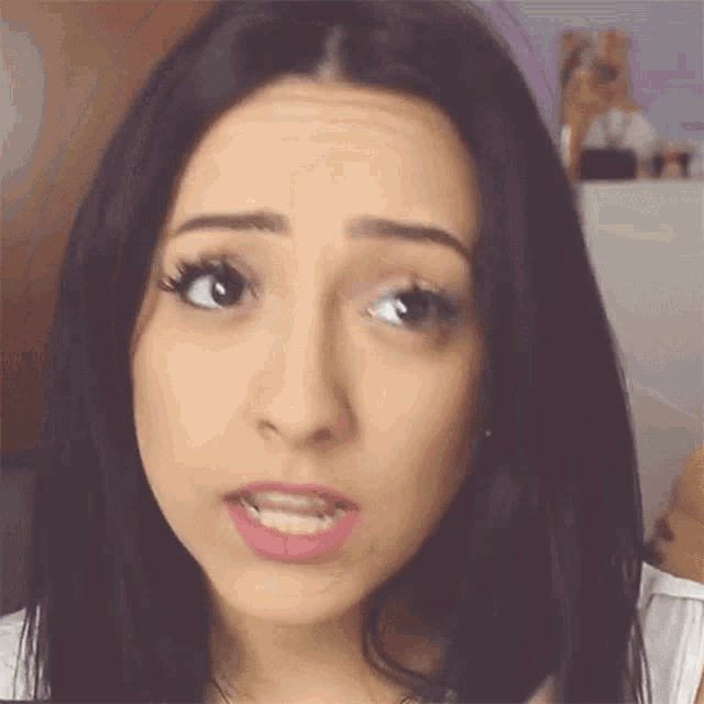 a close up of a woman 's face with dark hair
