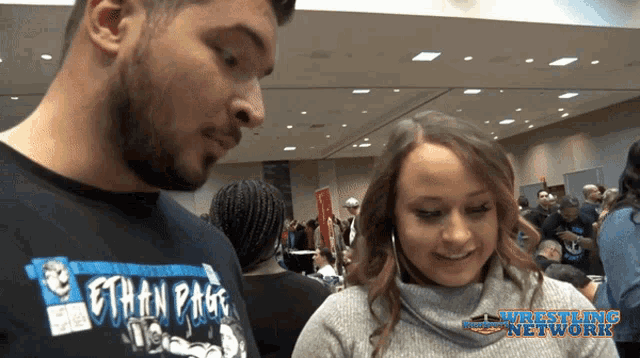 a man wearing a shirt with the name ethan page on it