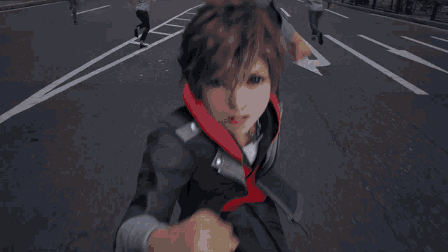 a person wearing a red hoodie and a black jacket