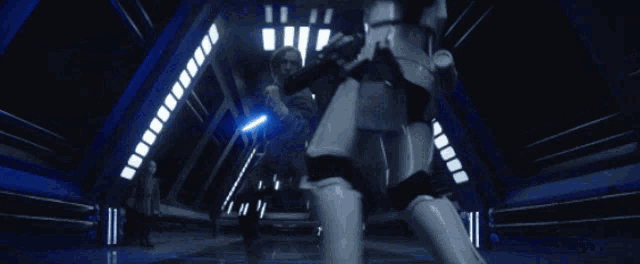 a storm trooper is laying on the floor in a dark room with a blue light behind him