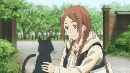 a girl is holding a black cat in her arms while standing in front of a fence .