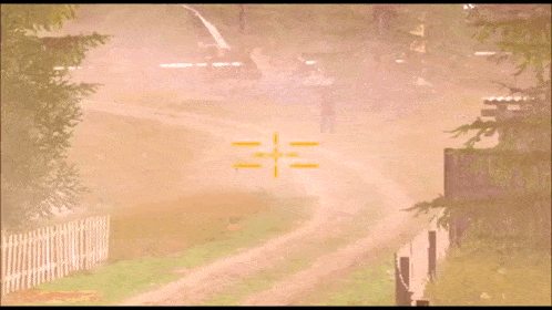 a man is walking down a dirt road with a cross in the distance