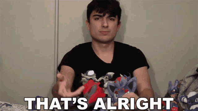 a man holding a stuffed animal with the words that 's alright below him