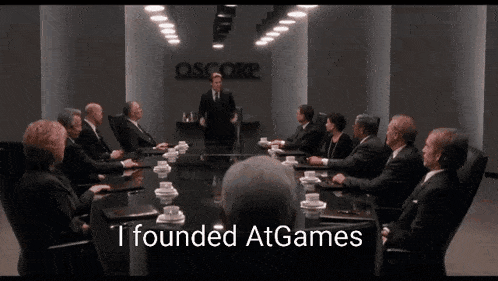 a group of people are sitting around a conference table with the words i founded atgames written on the bottom
