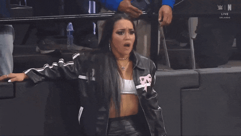 a woman wearing a leather jacket with the letter n on the front