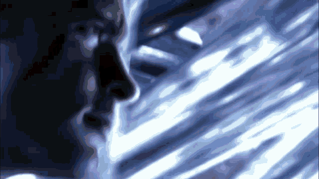 a close up of a man 's face with a blue light behind him