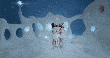 three women in white dresses are hugging in front of an ice sculpture