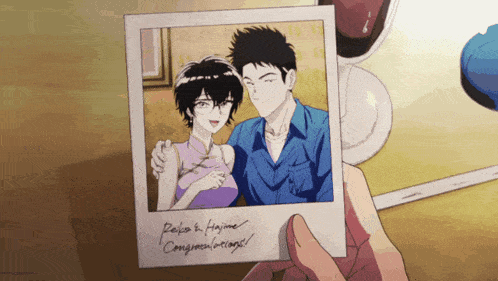 a person is holding a picture of a man and a woman with the words " riko & hajime " on the bottom