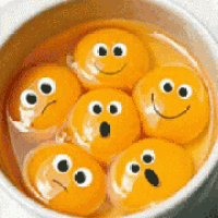 a bowl of orange balls with smiley faces drawn on them