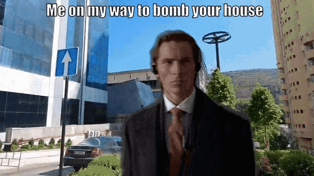 a man in a suit and tie is standing in front of a building and a sign that says me on my way to bomb your house