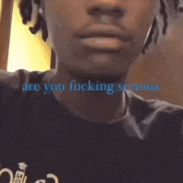 a close up of a man 's face with the words " are you fucking serious " written in blue