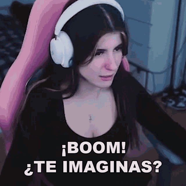 a woman wearing headphones is sitting in a pink chair and saying boom ! te imaginas ?