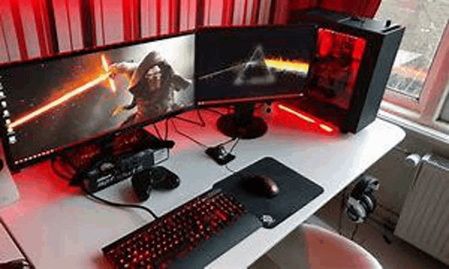 a computer desk with two monitors , a keyboard , a mouse , and headphones .