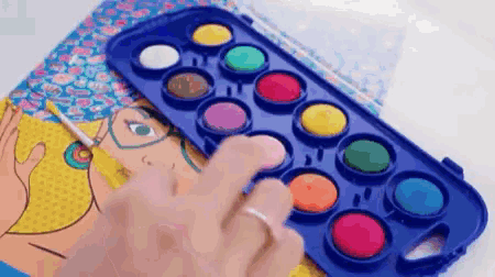 a person is painting a picture of a woman with glasses