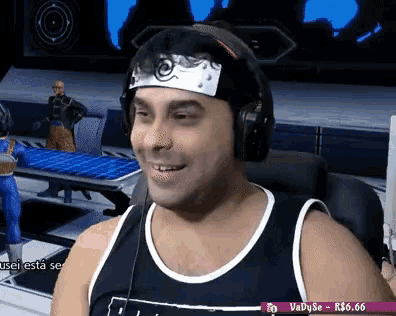 a man wearing a headband and headphones is smiling in front of a screen that says vadyse