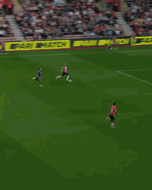 a soccer game is being played in front of a banner that says no room for racism