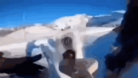 a blurry picture of a person standing in front of a snowy mountain