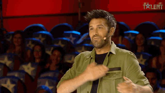 a man in a green shirt with the word talent on the bottom left