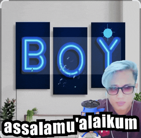 a man with blue hair is standing in front of a wall with the word boy written on it