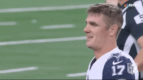 a football player is smiling on the field while wearing a number 17 jersey .
