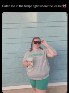 a woman wearing sunglasses and a california shirt is holding a cup of coffee