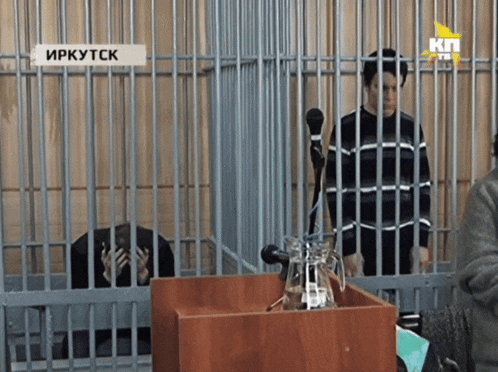 a woman in a jail cell with a sign that says irkutsk