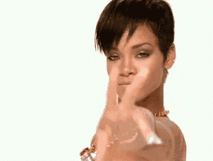 a woman is pointing her finger at the camera .