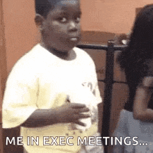 a young boy in a yellow shirt is standing in front of a woman and says `` me in exec meetings ... '' .