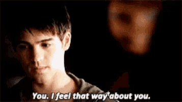 a man and a woman are standing next to each other and the woman says you i feel that way about you .