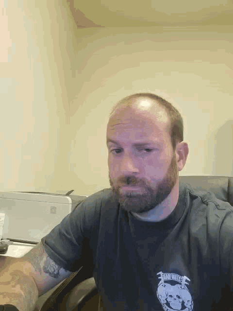 a bald man with a beard wears a shirt that says ' united states ' on it