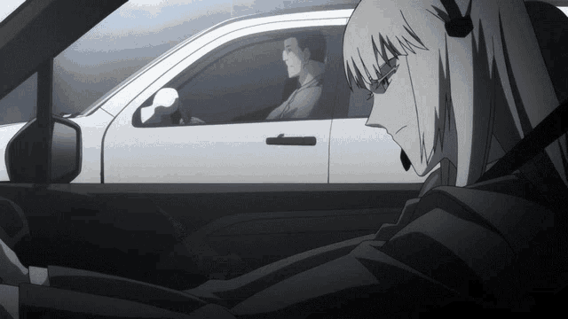 a man and a woman are in a car and the woman is wearing a headset
