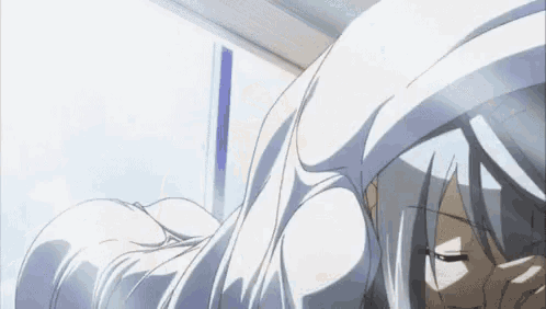 a woman with long white hair is laying in a bed with her eyes closed .