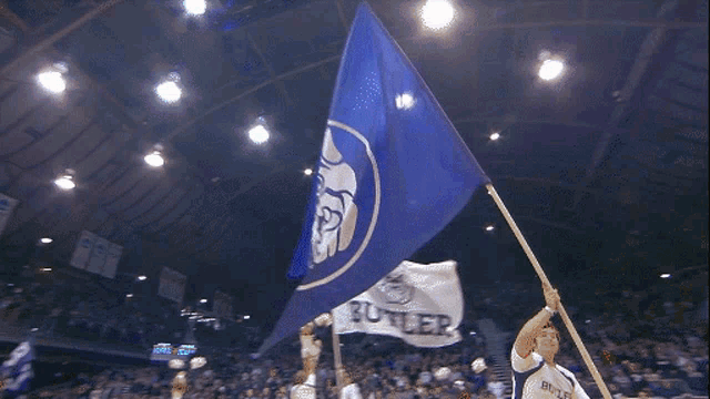 a blue flag with a white circle with the letter b on it