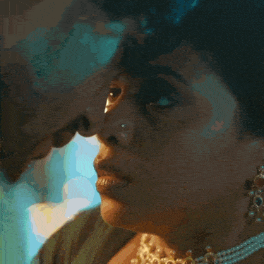 a man in a yellow shirt is kissing a woman