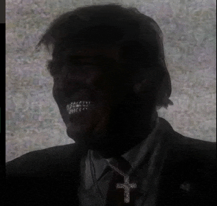a man wearing a suit and tie with a cross necklace