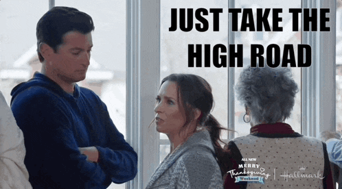 a man and a woman are standing in front of a window with the caption just take the high road