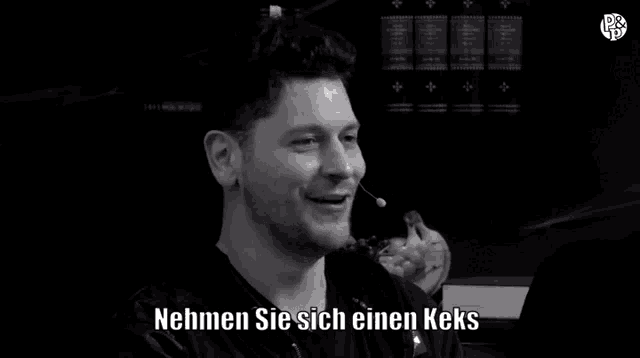 a black and white photo of a man with the words nehmen sie sich einen keks written below him