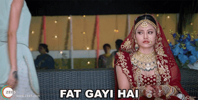 a bride is sitting on a couch with the words fat gayi hai above her