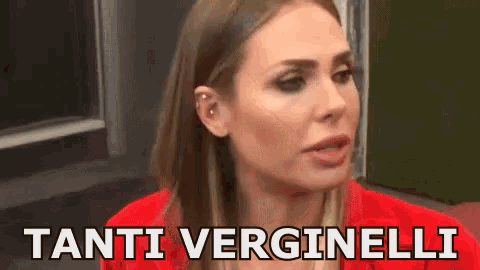 a woman in a red jacket is talking and says tanti verginelli .