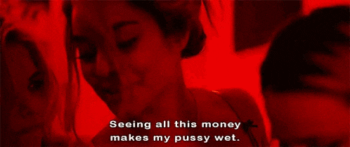 a couple of women are kissing and looking at each other .