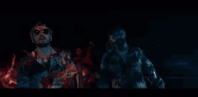 a man wearing sunglasses and a hawaiian shirt is making a funny face with his hands outstretched .