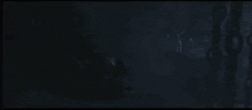 a dark background with a blurred image of a person in the dark